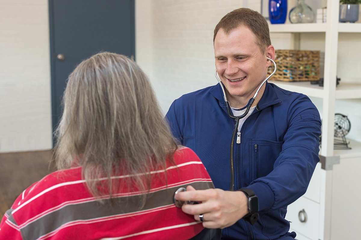 Nurse helping a resident at Norwood Towers