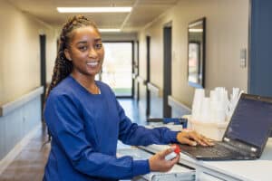 Nurse at a Nurse's cart in the hallway at Norwood Towers